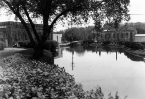 Mill pond at the end of the mill race about 1940. The building at the left is the Wisconsin Power & Light Company where the electric generator driven by water power was located in the 1900’s.